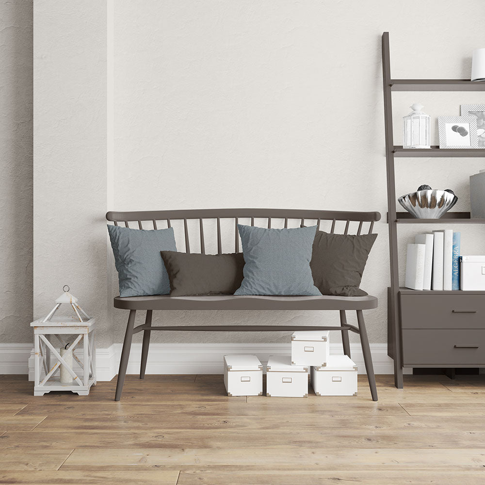 Cushions covered in Tide Herringbone fabric NJ25-444 in blue and taupe on a dark wood slat-back bench, beside a ladder shelf and white storage boxes.