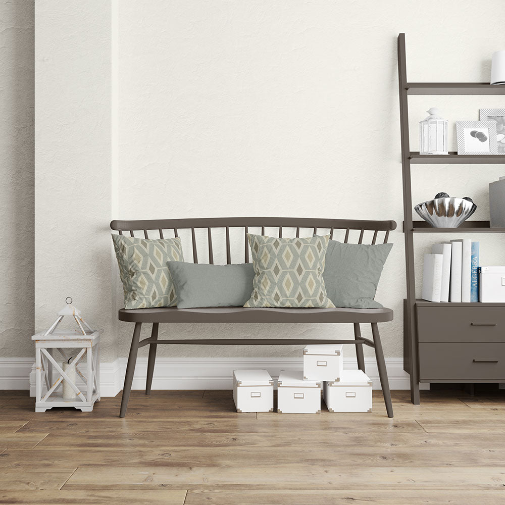 Dark metal-framed modular seating with four cushions (two geometric pale blue patterns, two solid gray) on light wood floor.