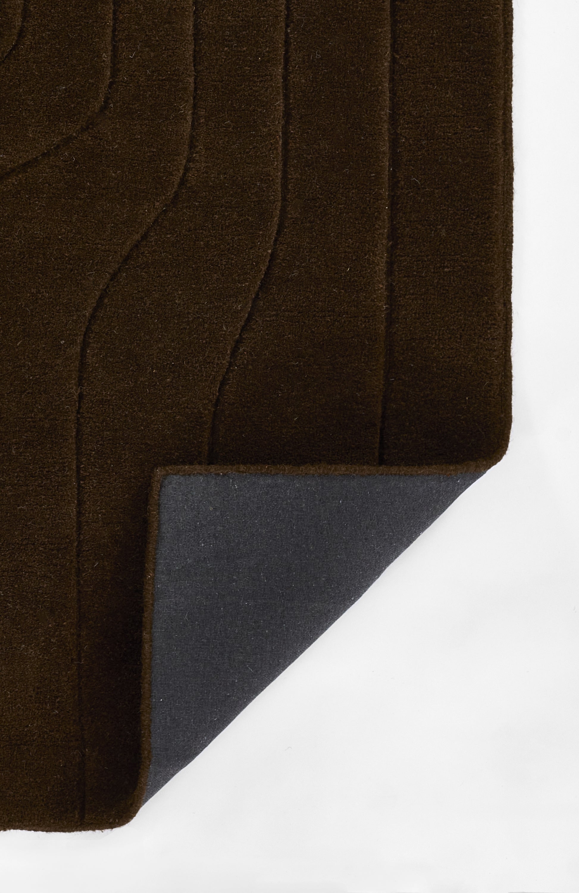 Deep brown velvet rug with wavy channel stitching; folded corner reveals gray backing.