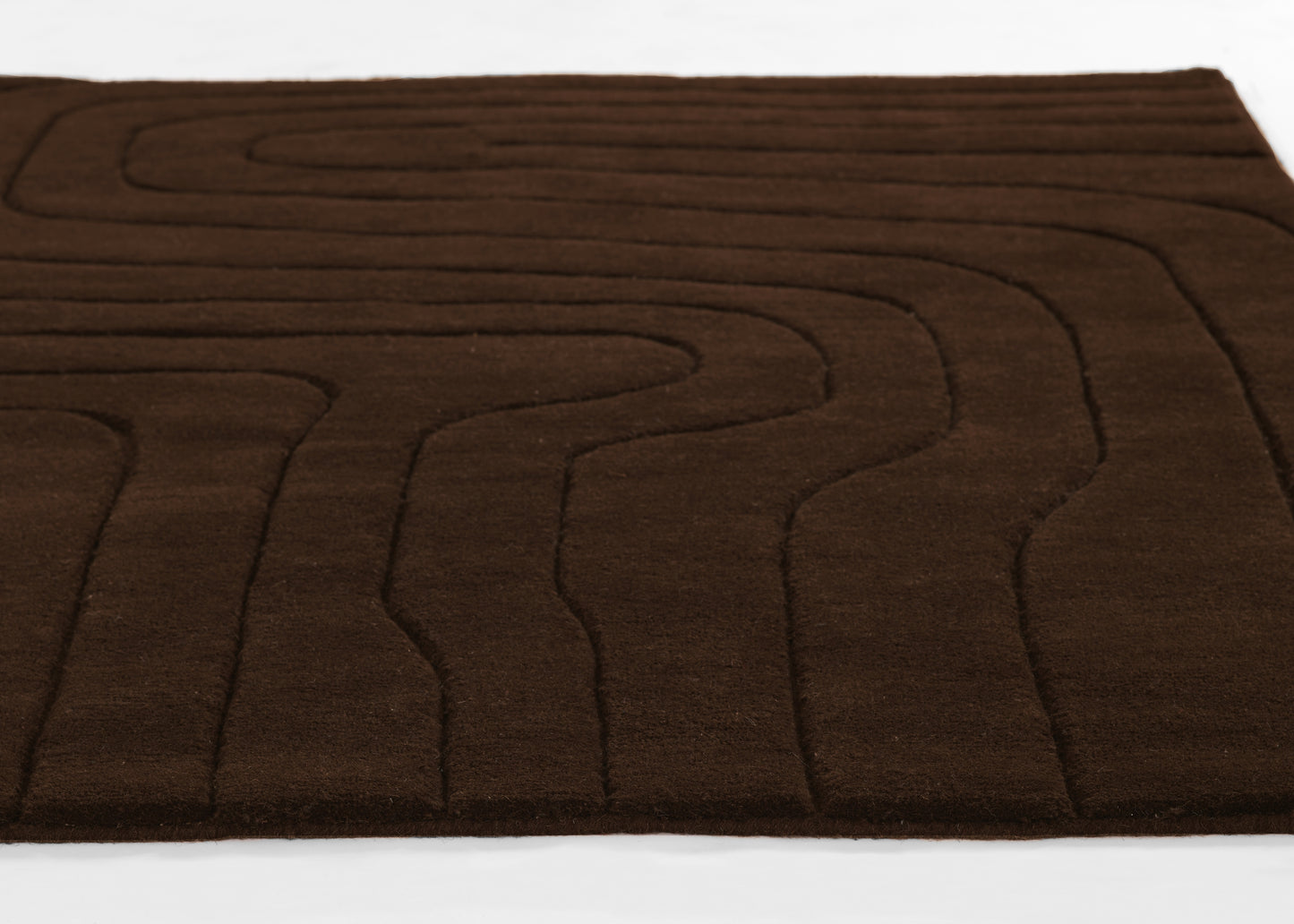 Brown plush area rug (5' x 8') with abstract wavy line stitching and soft texture.