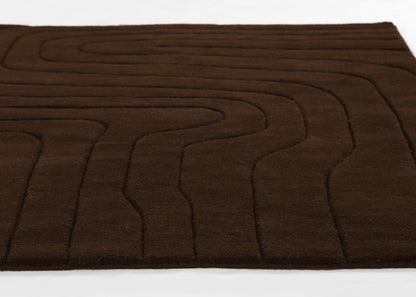 Brown plush area rug (5' x 8') with abstract wavy line stitching and soft texture.