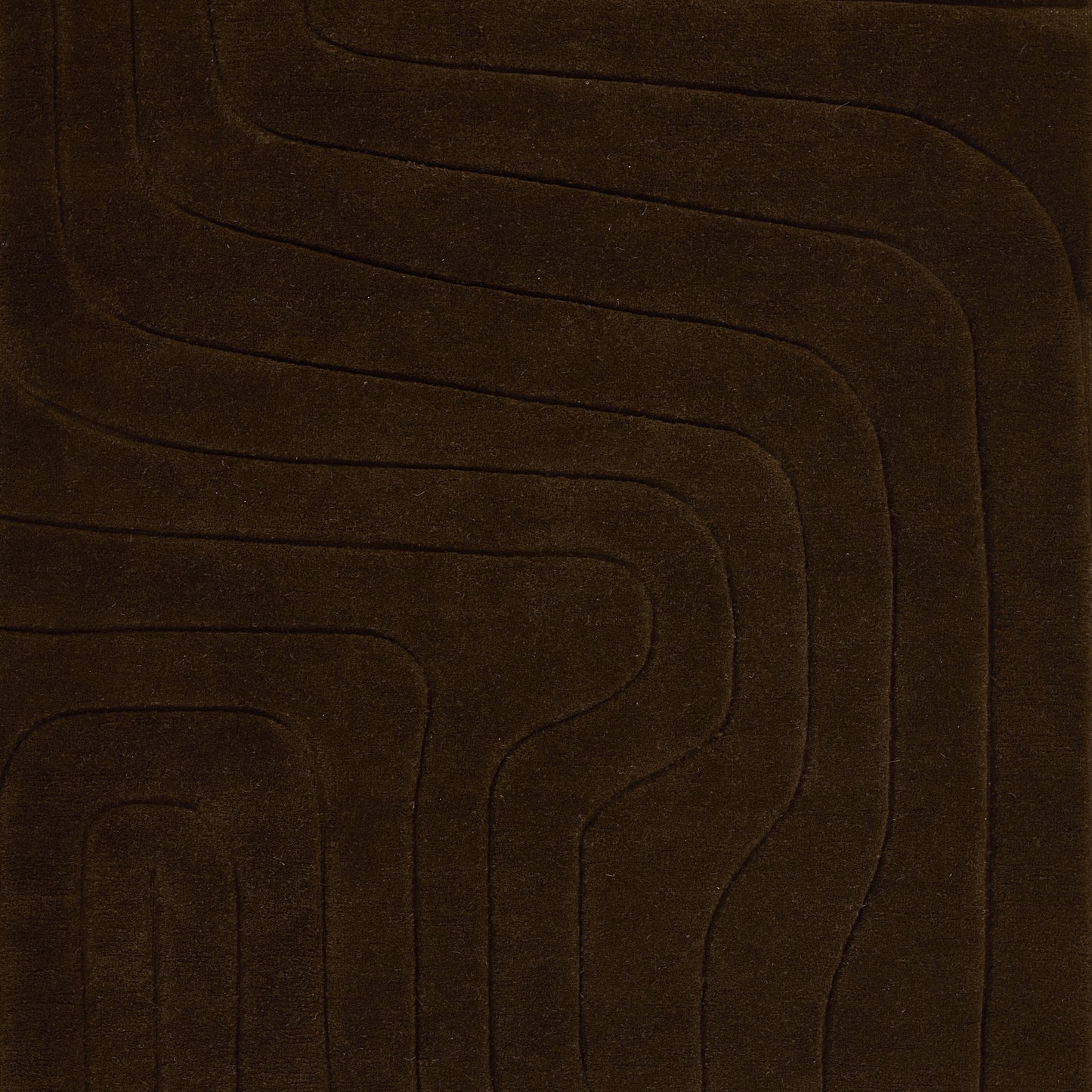 Dark brown plush rug featuring a wavy concentric line pattern for a modern geometric floor accent.
