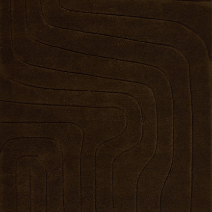 Dark brown plush rug featuring a wavy concentric line pattern for a modern geometric floor accent.