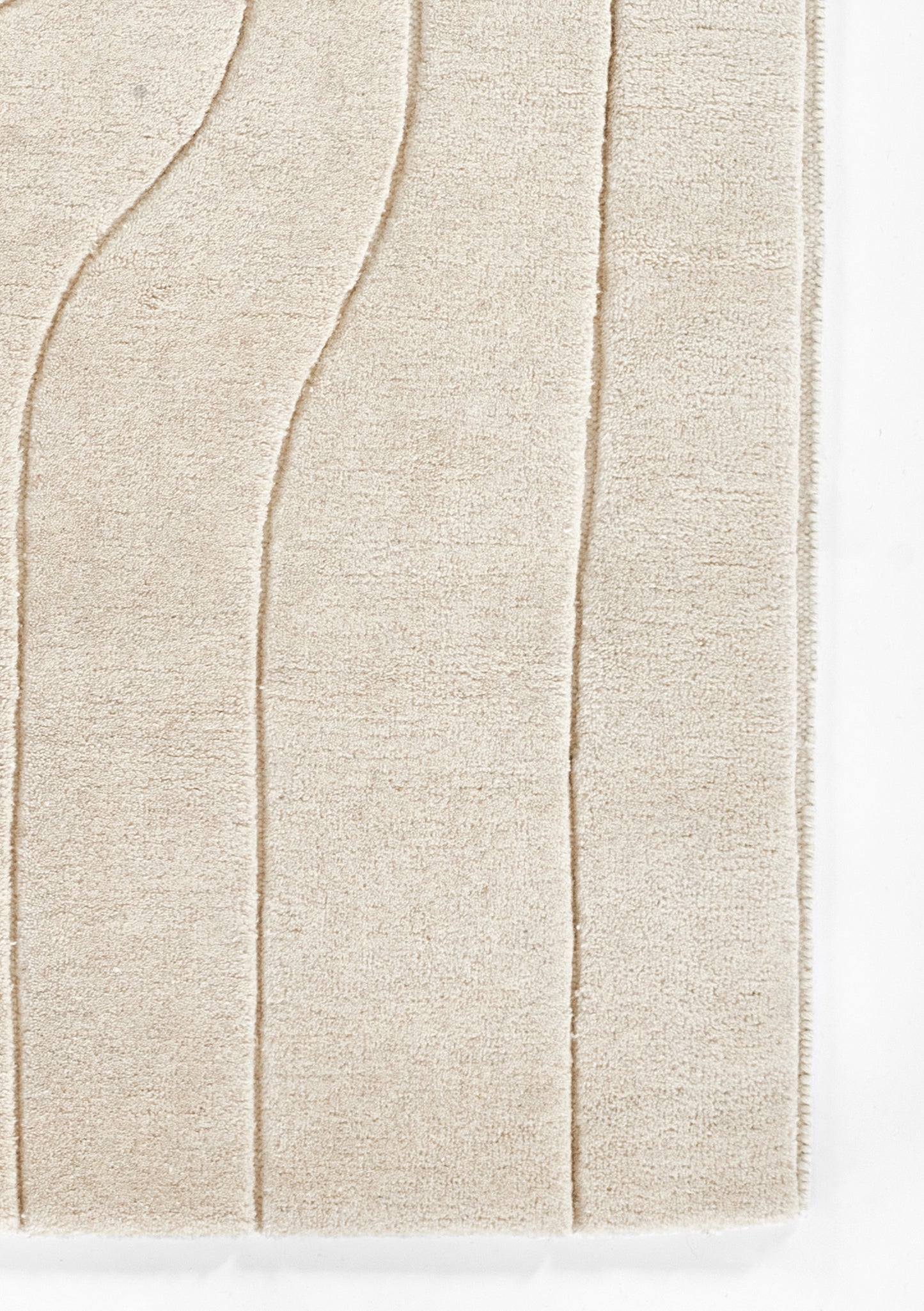 Ivory shag rug with plush textured pile and curved wave pattern for cozy living spaces.