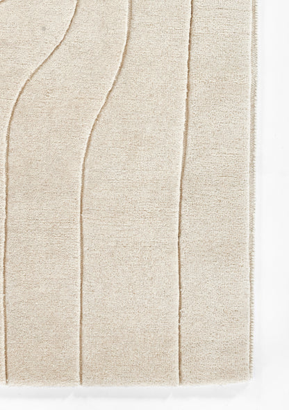 Ivory shag rug with plush textured pile and curved wave pattern for cozy living spaces.