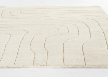 Cream ivory rug with soft pile and raised abstract curved lines for a modern look.