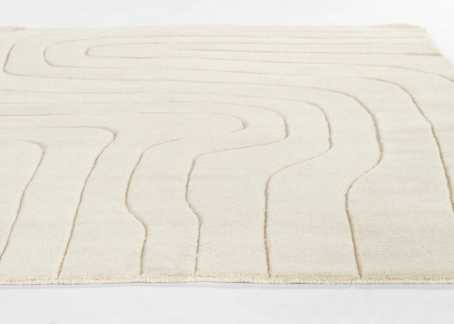Cream rug with raised wavy lines forming an abstract maze, plush soft texture and clean modern look.