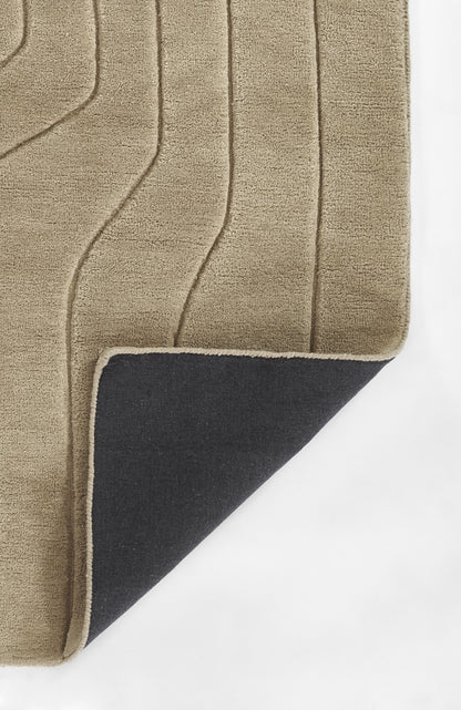 Beige shag rug with raised curved lines; folded corner reveals dark navy underside and beige binding.