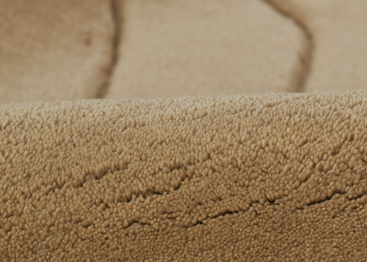 Beige sherpa fleece fabric close-up with fluffy plush pile and warm cozy texture.