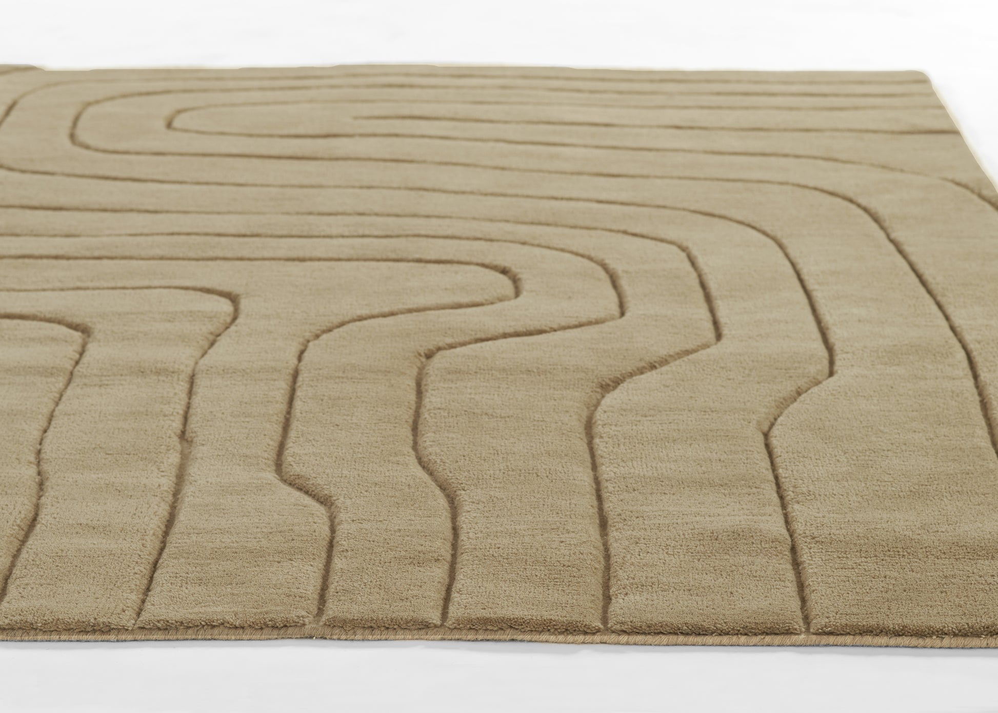 Beige rectangular area rug with warm tones and abstract raised lines forming a maze-like pattern.
