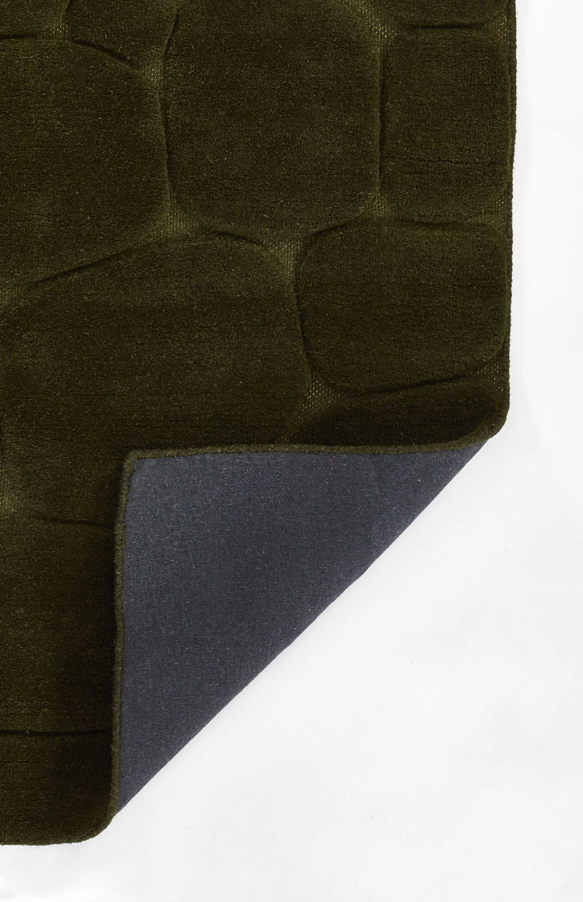 Olive green quilted fabric with square padding; navy underside peeks at corner, plush throw blanket.