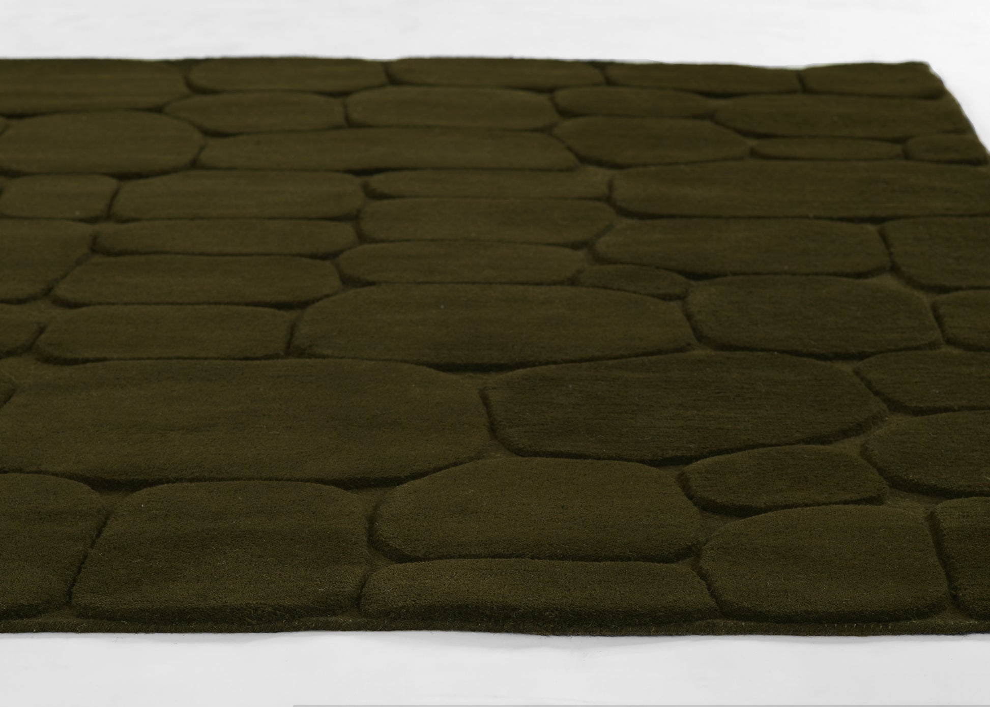 Olive green shag rug with irregular pebble-shaped panels and plush, textured surface; perfect as a cozy floor accent.