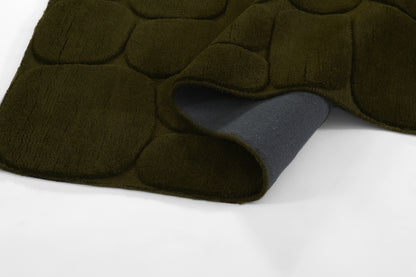 Olive-green plush rug with bubble-quilt texture; blue underside peeks out.