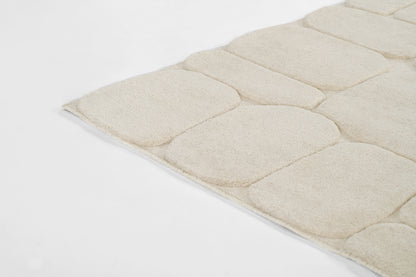 Momeni Canyon 5×8 hand-tufted wool area rug in ivory with high/low carved texture, organic pebble-inspired pattern for living room or bedroom decor, neutral natural wool rug enhancing contemporary and bohemian interiors.