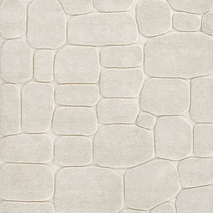 Cream beige pebble-stone texture with rounded rectangular shapes and subtle grout; decorative wall tile pattern.