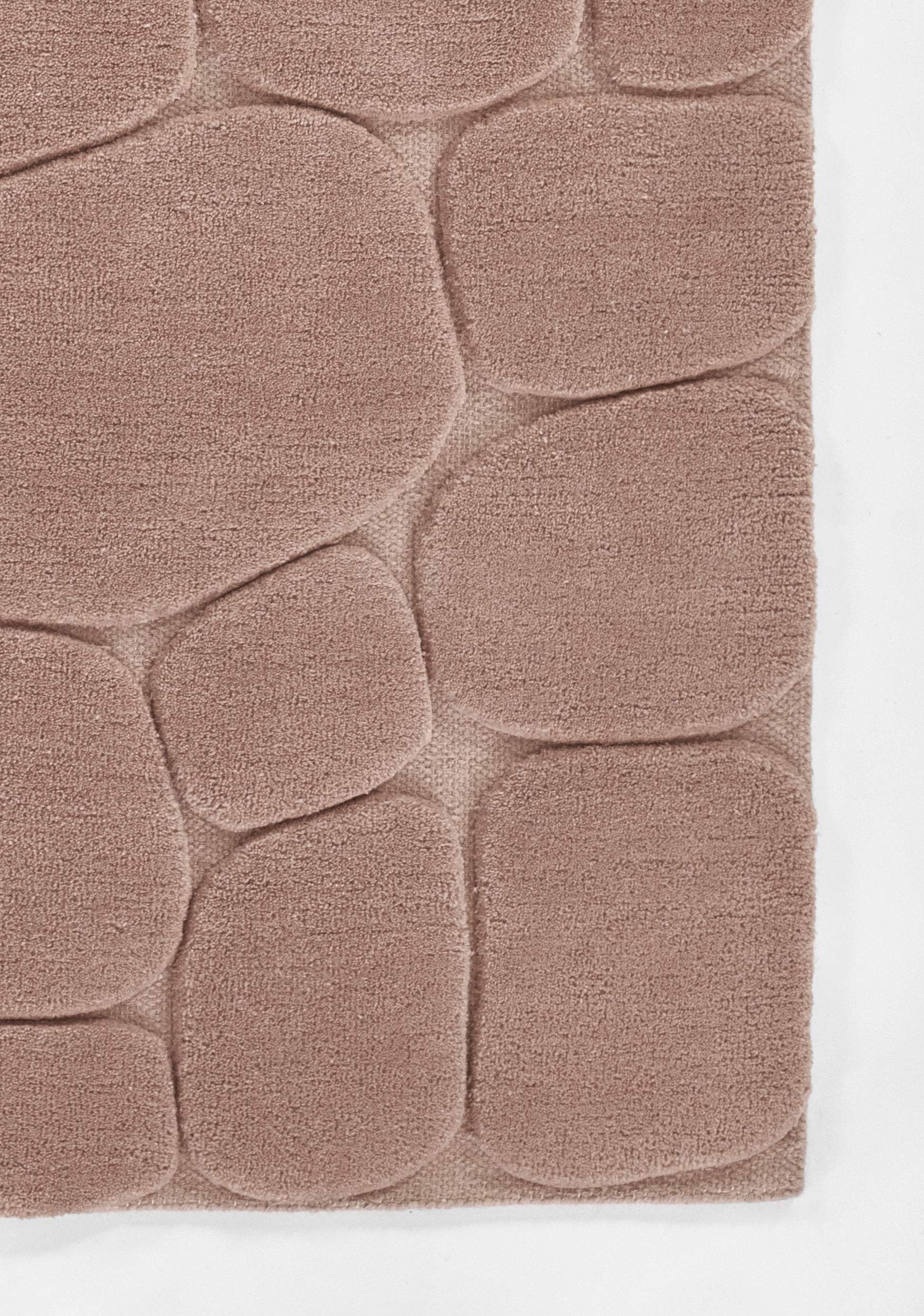Soft pink shag rug with rounded pebble-patterned panels and plush pile.