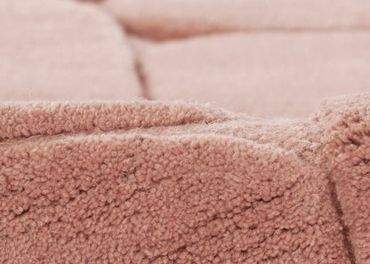 Soft pink sherpa fleece fabric with fluffy texture and visible seam, cozy jacket style.