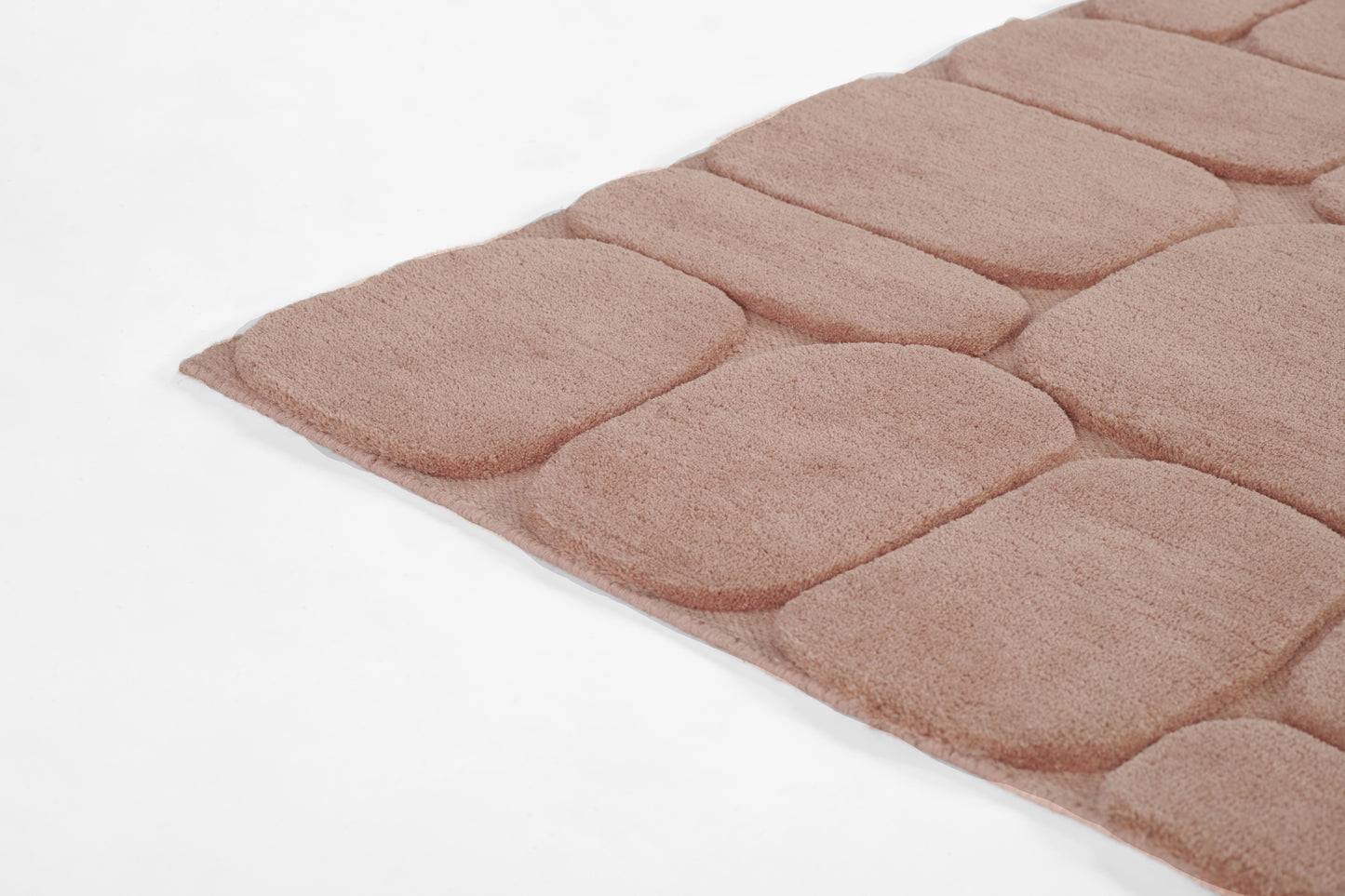 Dusty pink tufted shag rug with large rounded square panels and plush soft texture.