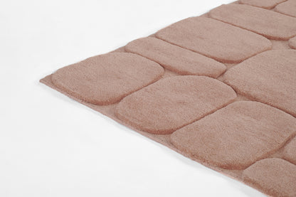 Dusty pink tufted shag rug with large rounded square panels and plush soft texture.
