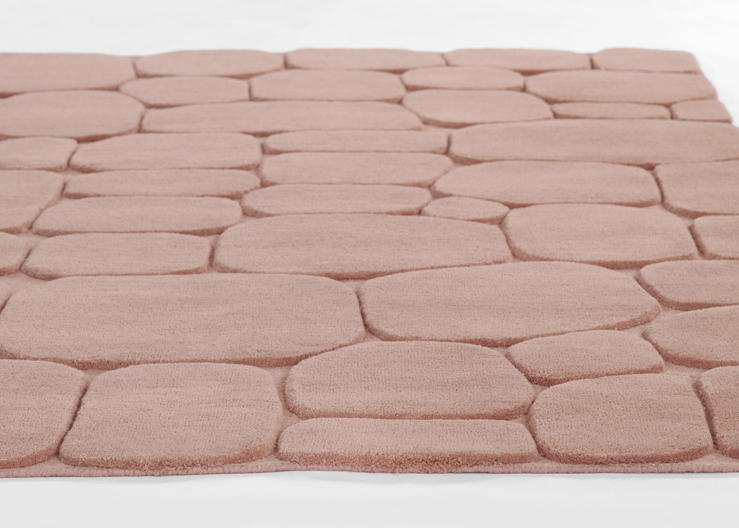 Soft pink pebble-pattern rug with plush, rounded stone-like squares for cozy decor.