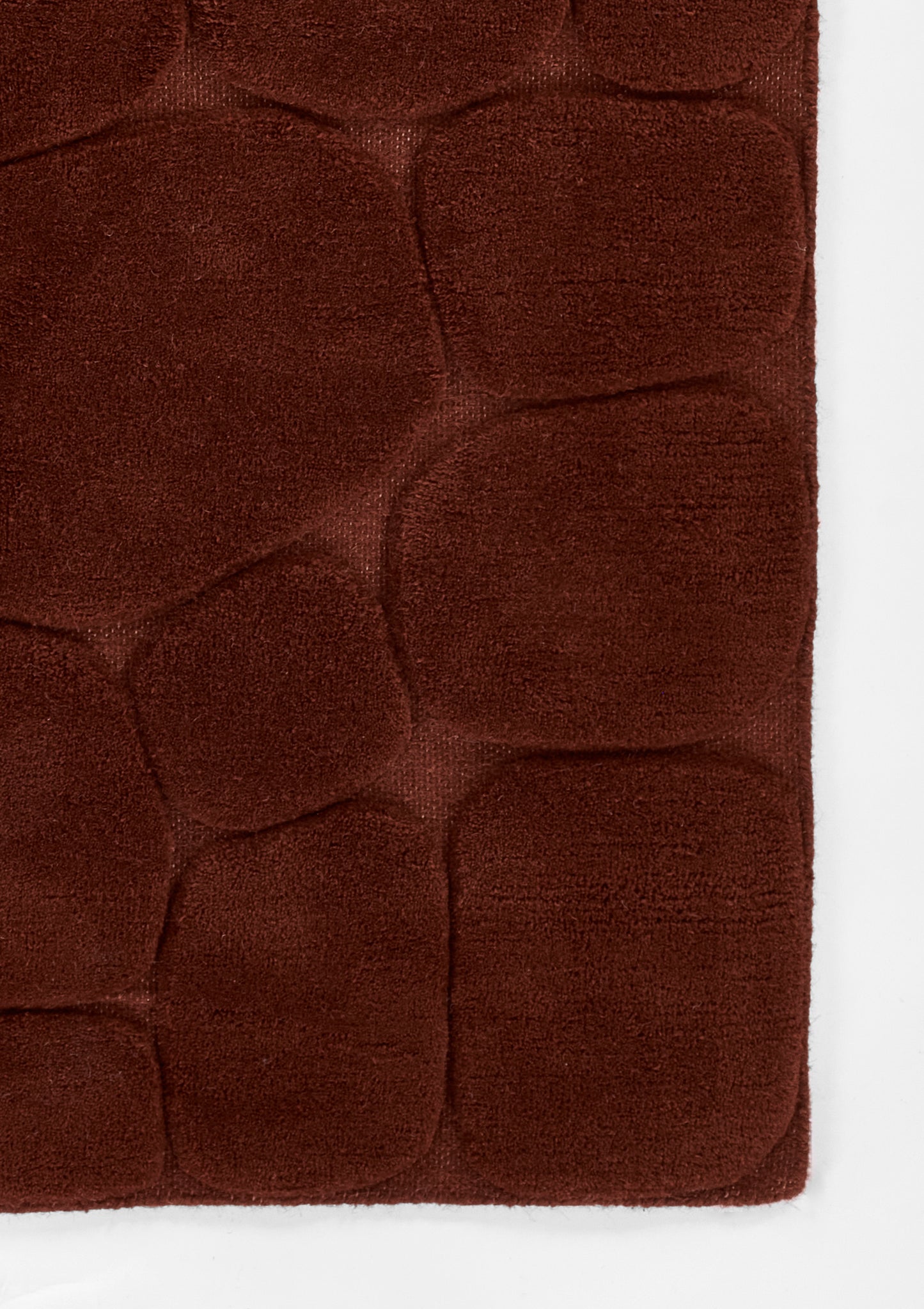 Dark rust-brown plush microfiber rug with quilted pebble pattern and rounded square panels, 8' x 10'.