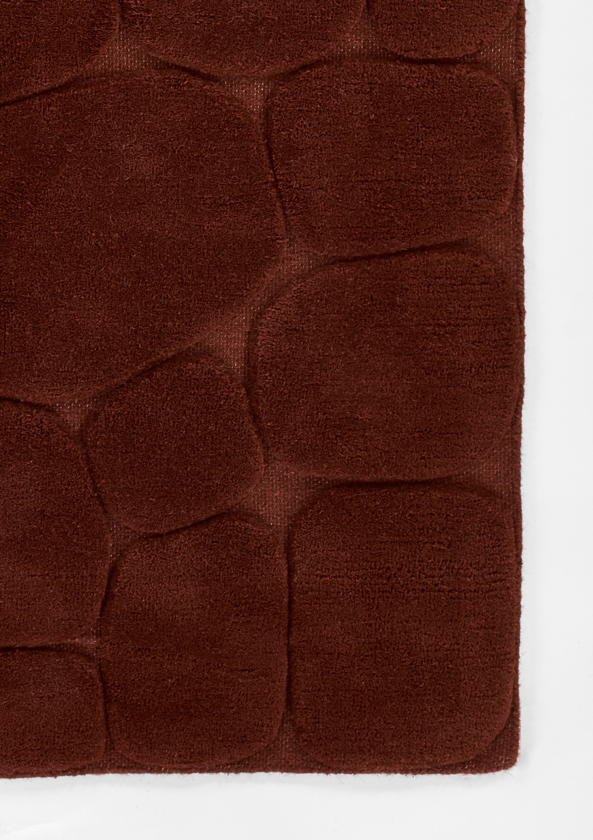 Dark rust-brown plush microfiber rug with quilted pebble pattern and rounded square panels, 8' x 10'.