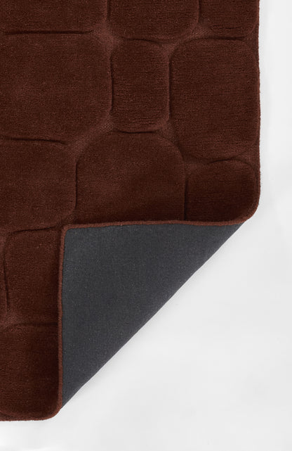 Plush burgundy tufted rug with rounded square block pattern; corner reveals blue-gray underside.