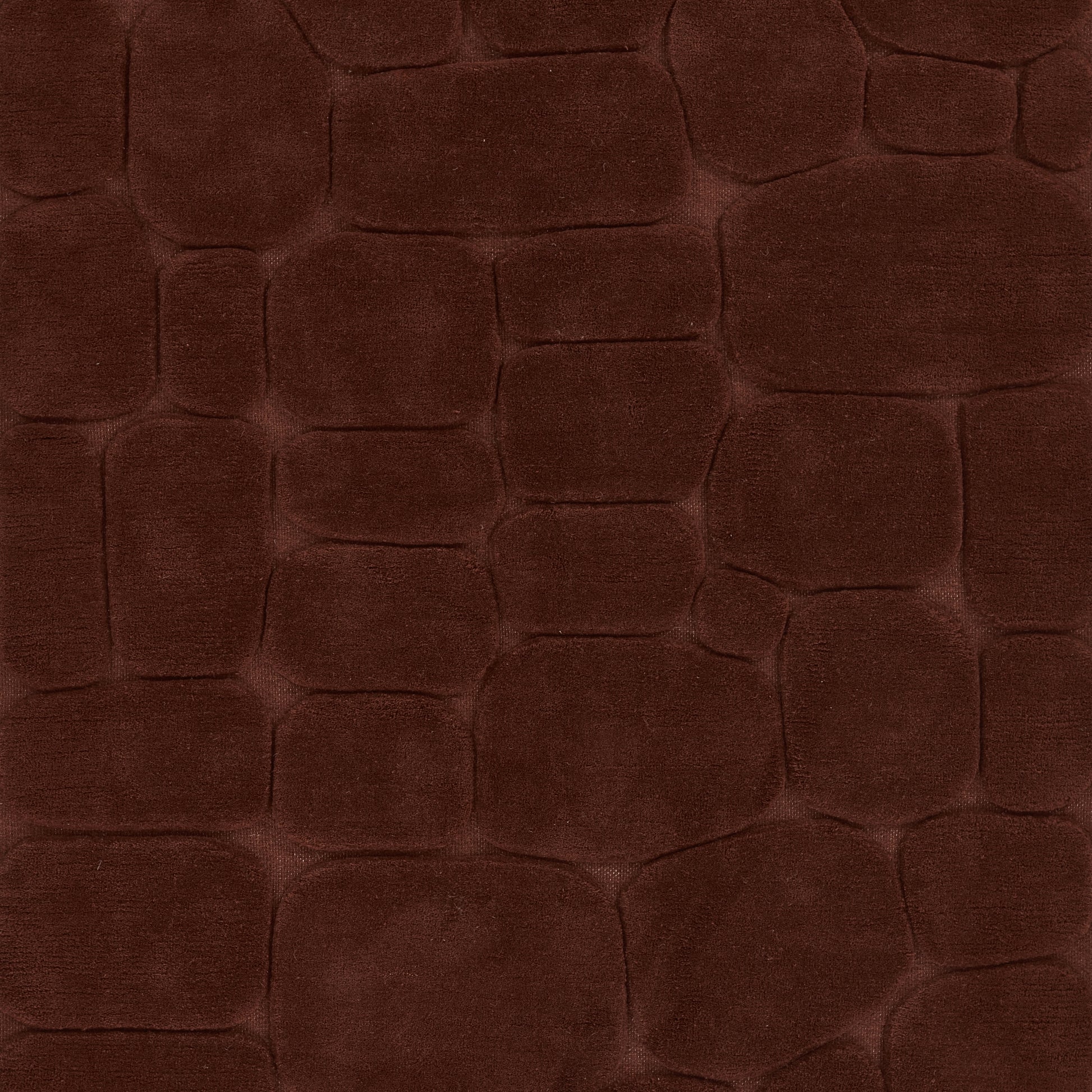 Dark brown crocodile-embossed rug with irregular scale pattern and suede-like finish.