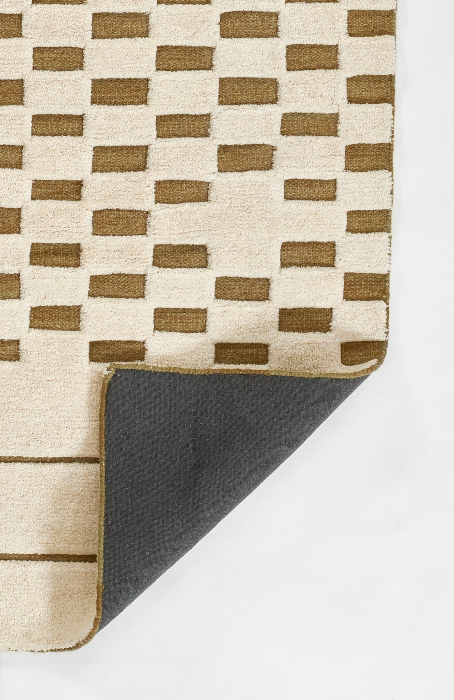 Soft beige plush rug with brown rectangular blocks in a geometric grid; 8' x 10' rug; folded corner reveals dark gray underside.