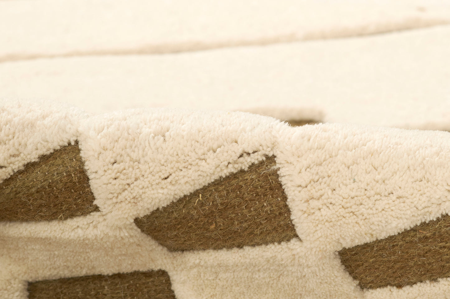 Beige shag rug with brown diamond pattern; soft plush pile; 8' x 10'.
