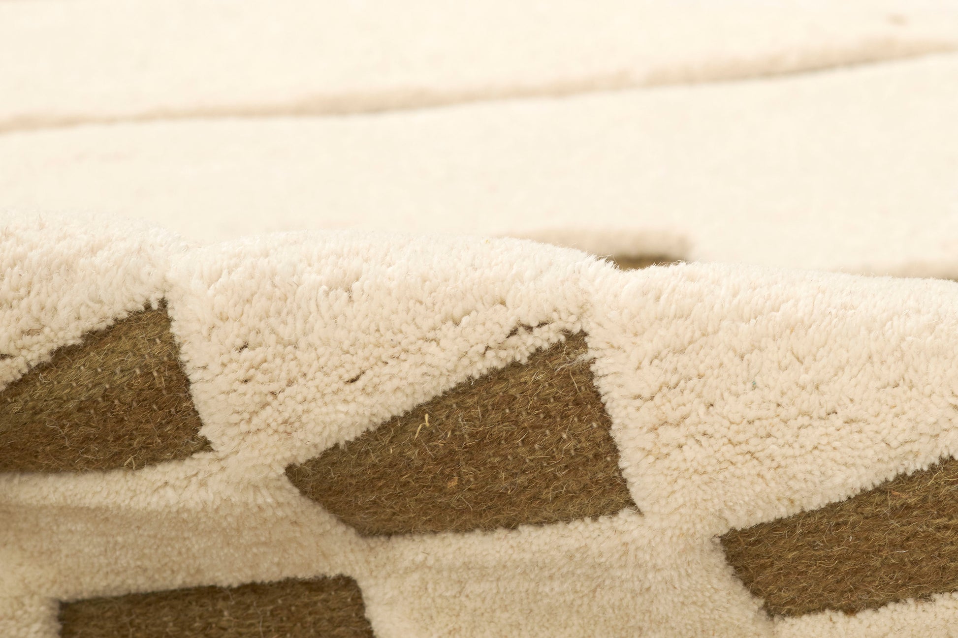 Beige shag rug with brown diamond pattern; soft plush pile; 8' x 10'.