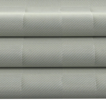 Light gray textured upholstery fabric rolls with a subtle dotted weave; durable home furniture fabric.