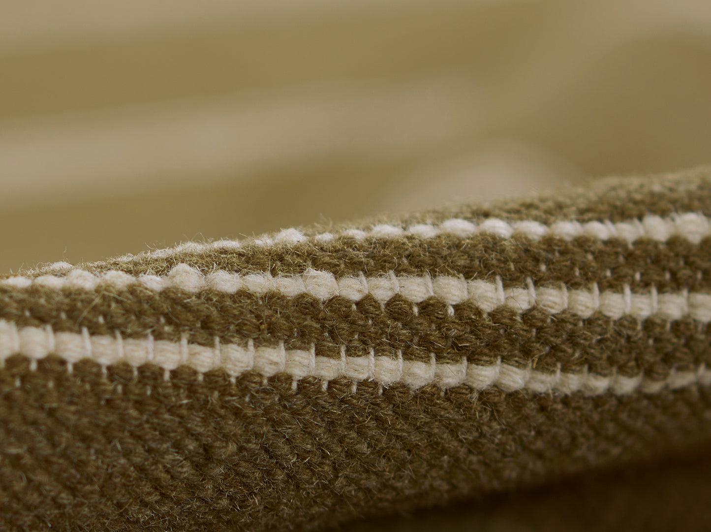 Brown & cream striped woven rug close-up with chunky loop texture.