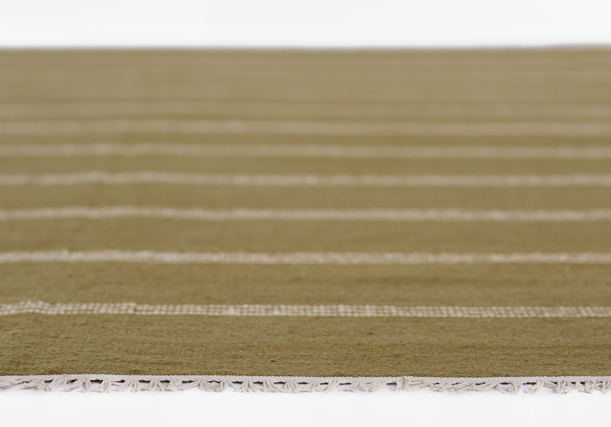 Olive-green rug with white horizontal stripes and tassel fringe along the edge.