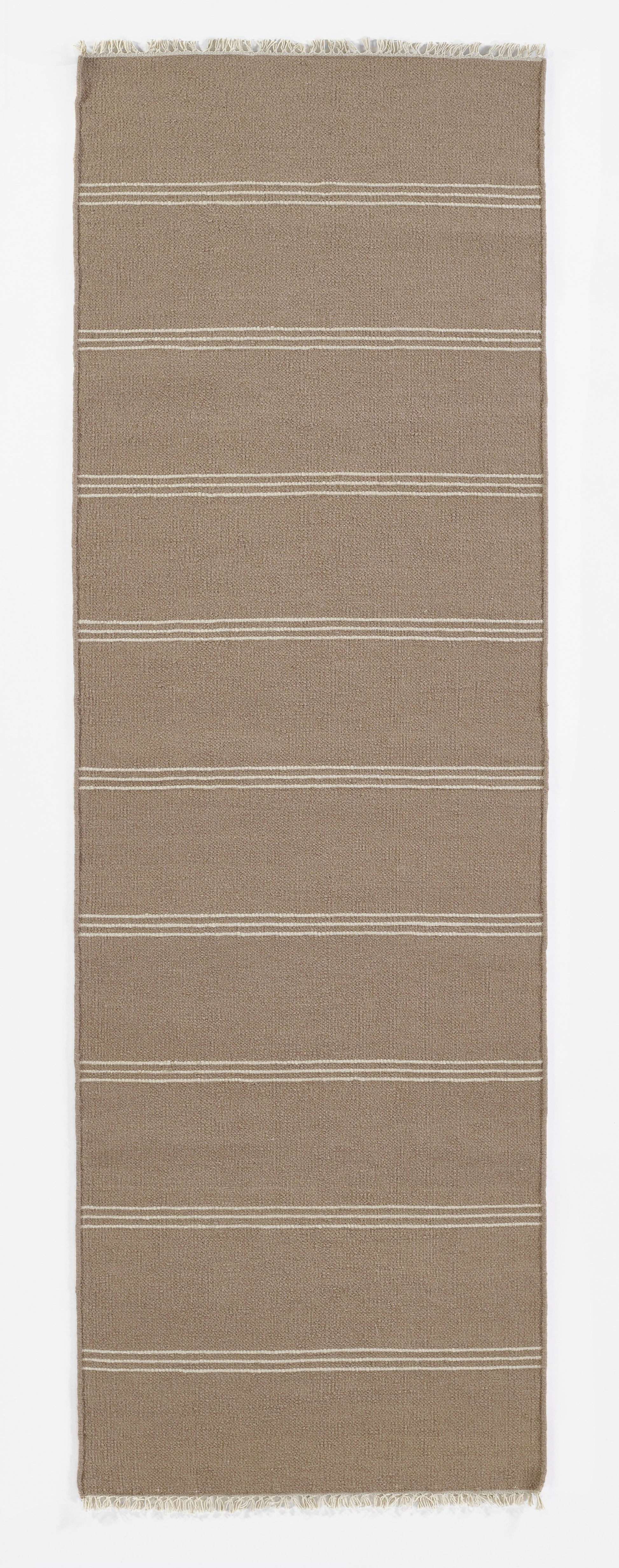 Taupe woven rug runner with horizontal white stripe bands and fringed ends.