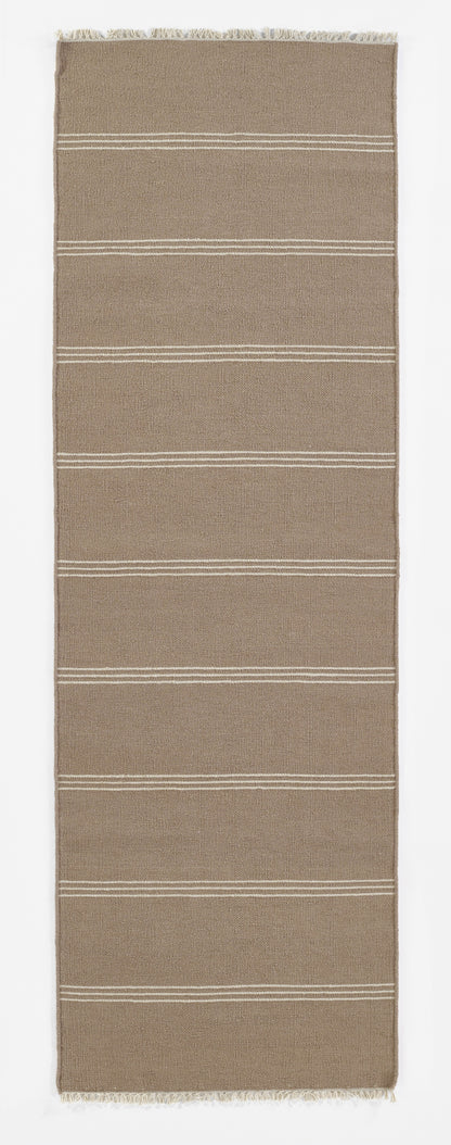 Taupe woven rug runner with horizontal white stripe bands and fringed ends.
