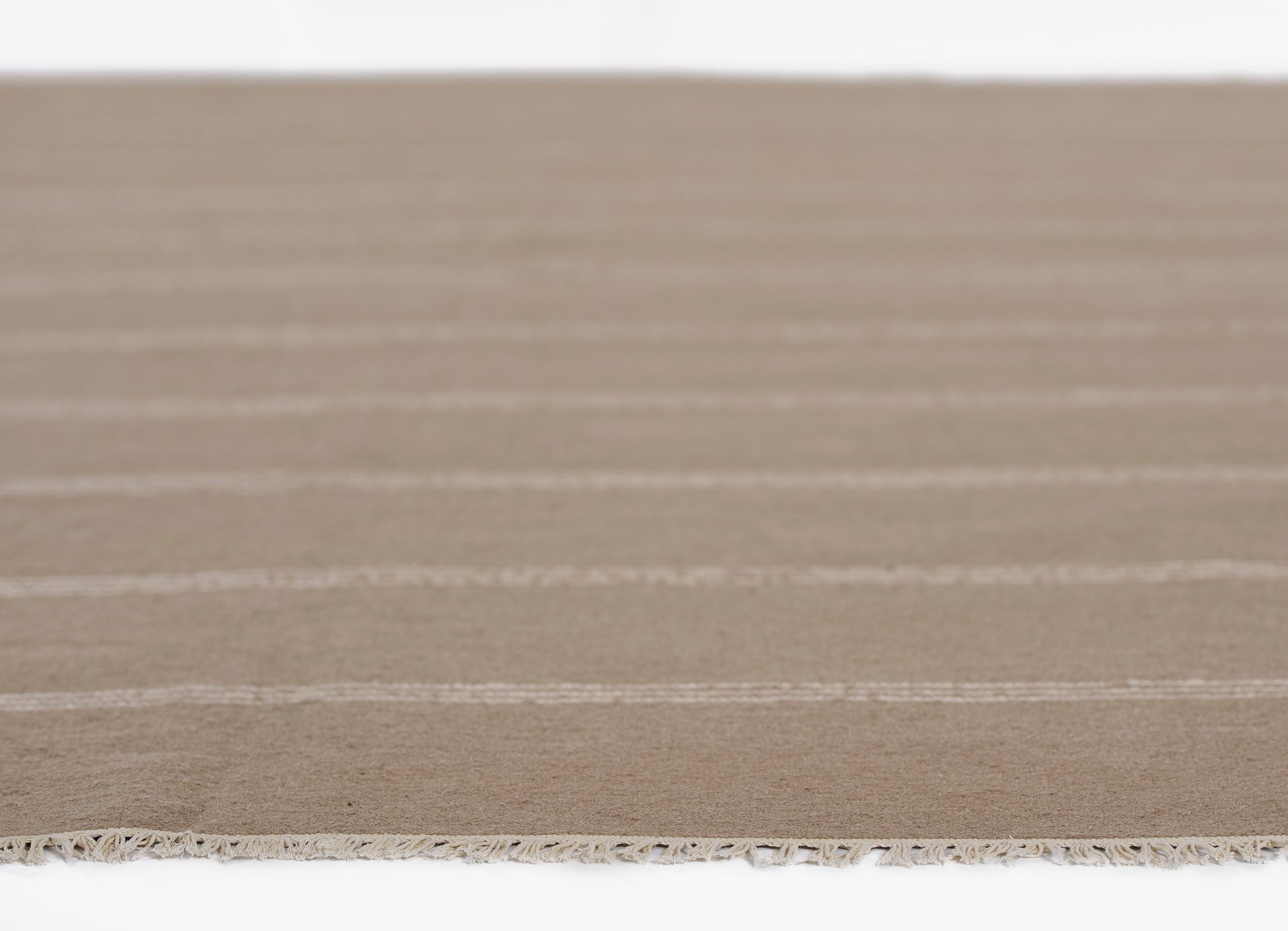 Tan flatwoven runner with cream stripes and fringed edge