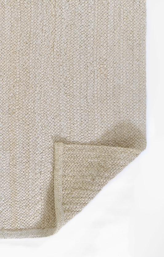 Beige textured woven rug with chunky loop pile, folded corner, cozy home decor.