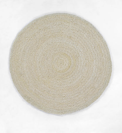 Beige natural jute rug with tight circular woven texture, flat-weave, artisanal coastal style.
