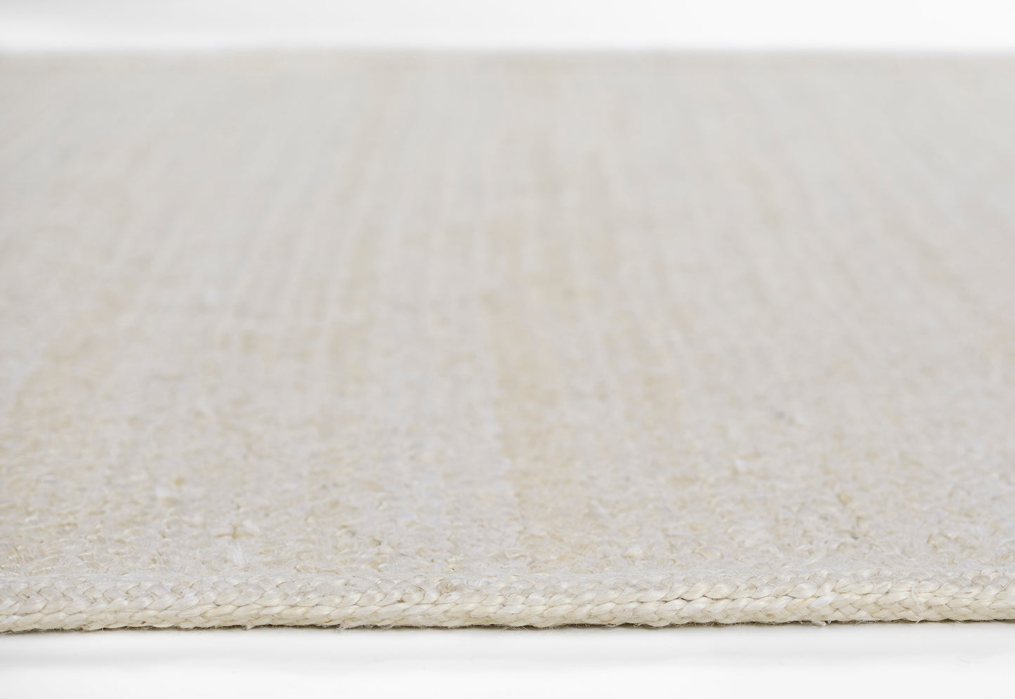 Beige woven area rug with a cream-toned braided edge and a textured striped surface, 8' x 11'.