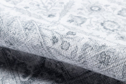 Grey patterned rug with plush pile and distressed motif, rolled edge, light and charcoal tones for contemporary decor
