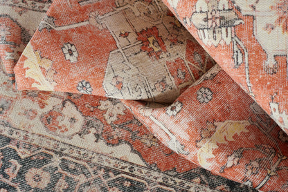 Distressed orange-cream oriental rug with floral medallions and intricate border, woven floor rug for living areas.