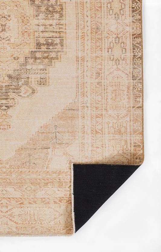 Beige vintage-style oriental rug with peach and brown faded patterns; corner folded to reveal black underside.