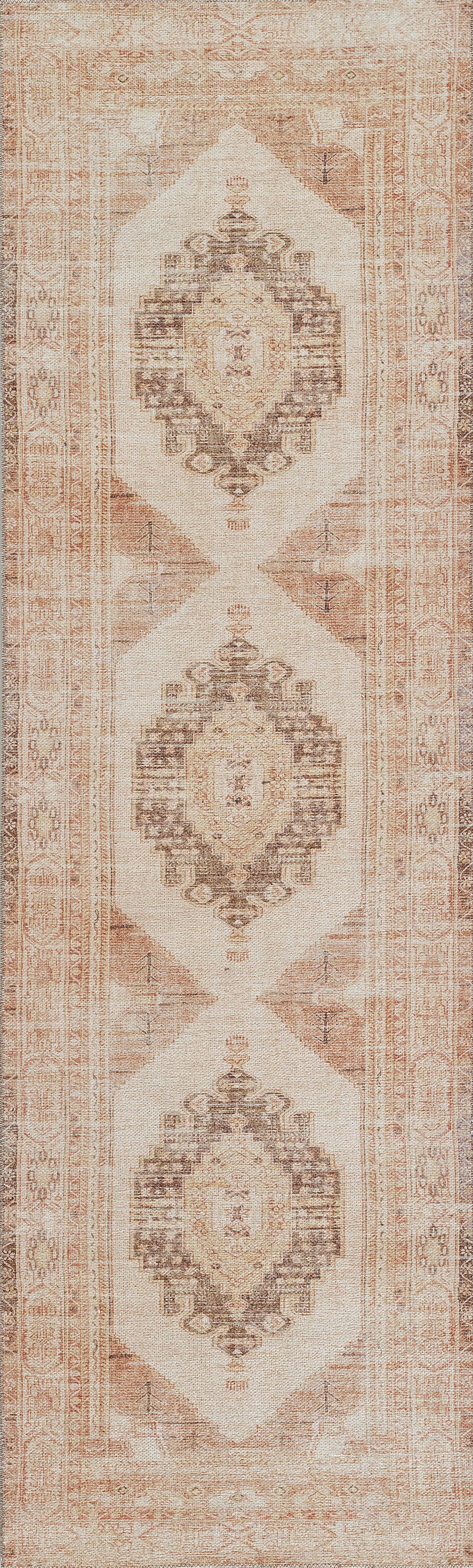 Distressed cream oriental rug with peach-brown diamond medallions.