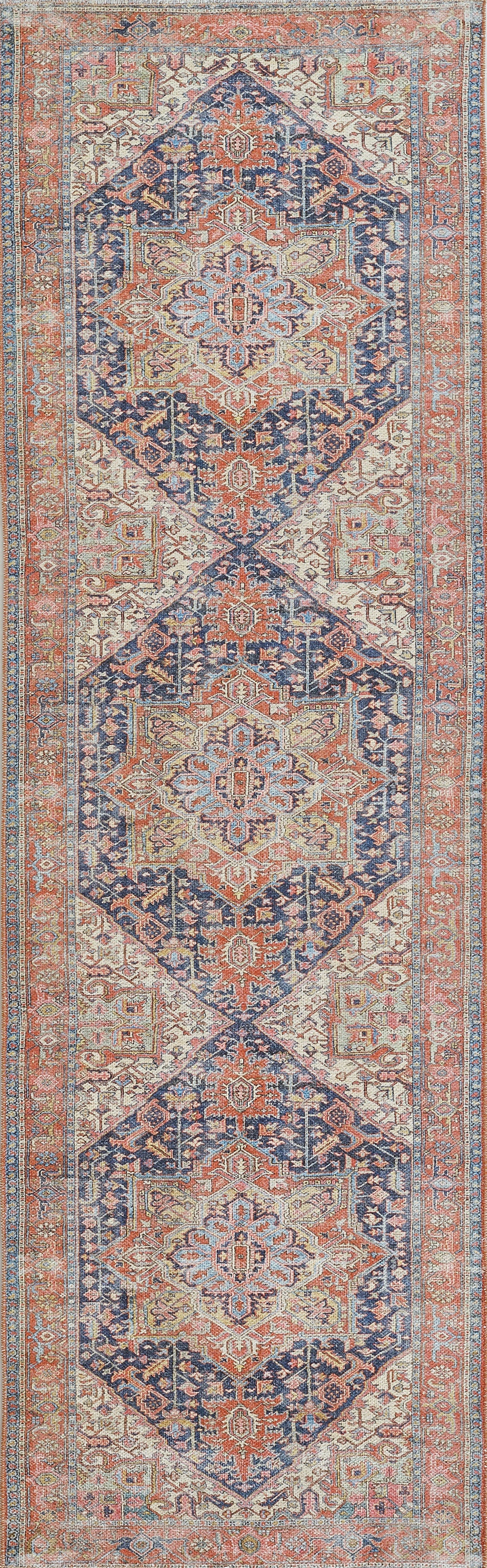 Navy and coral oriental area rug with ivory accents, repeating geometric medallions and decorative border.