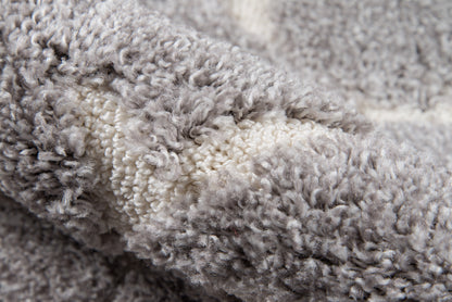Grey and ivory plush shag rug with thick, fluffy pile—cozy throw-style floor cover.