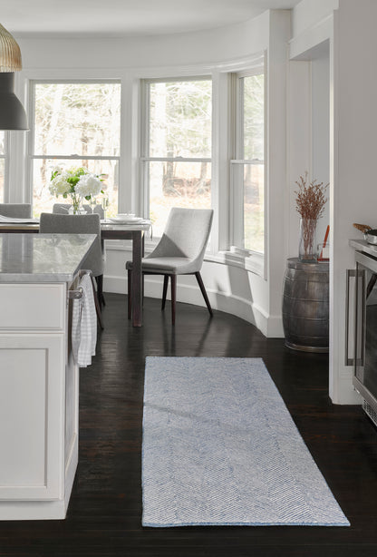 Blue & white chevron runner rug on dark wood floor in bright white kitchen, rectangular, modern farmhouse style.