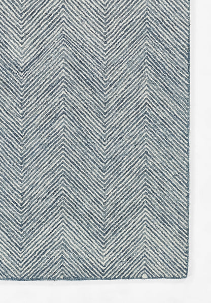 Blue and white chevron woven rug with textured zigzag pattern, modern geometric decor.