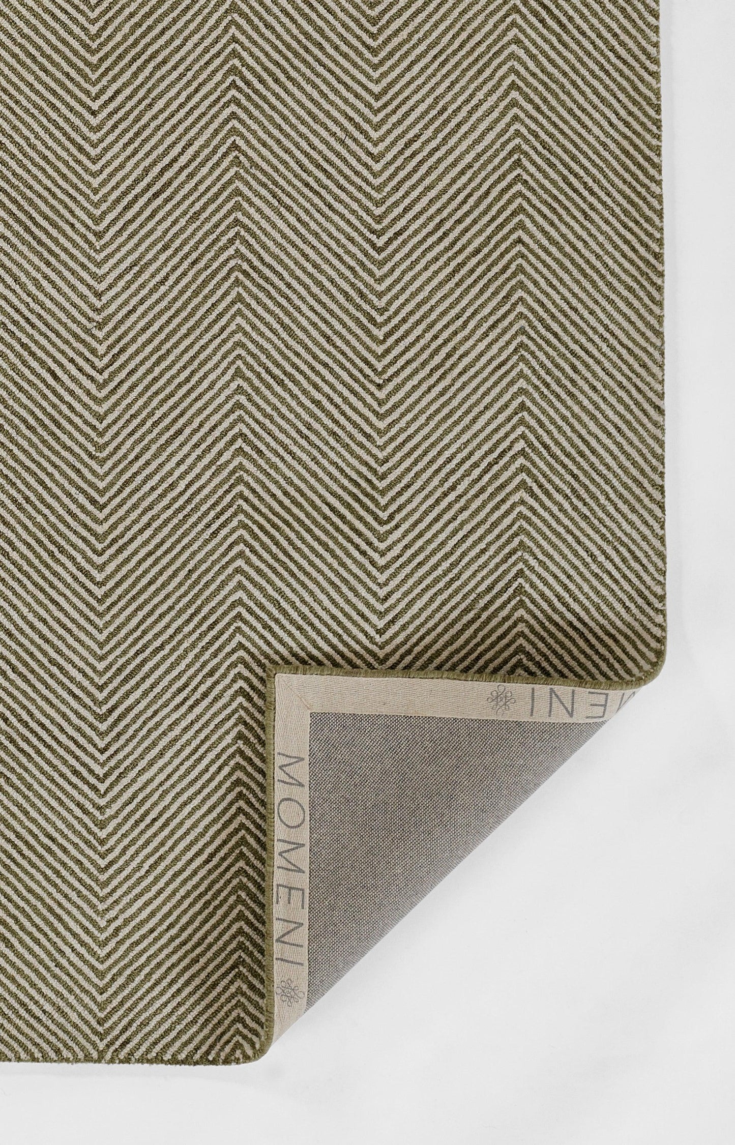 Olive-green chevron fabric swatch with cream diagonal lines; folded corner reveals beige backing and a visible MEM label.