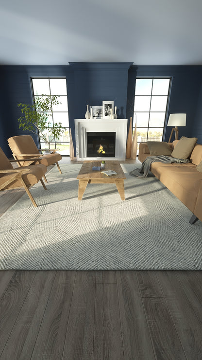 Navy living room with white fireplace, beige mid-century chairs, light gray chevron rug, natural wood coffee table.